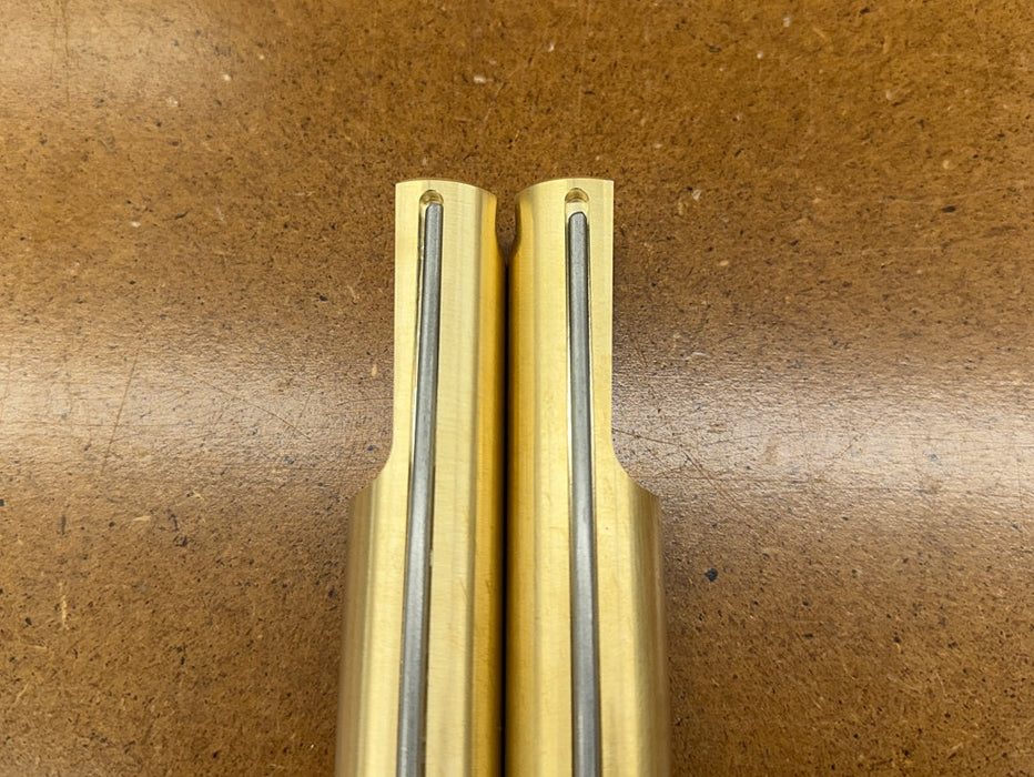 Two Rob Cosman Brass 1-inch benchdogs showing the primary and secondary faces with negative rakes